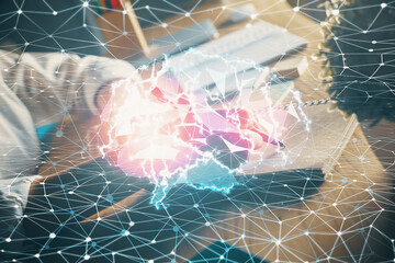 Multi exposure of writing hand on background with brain hologram. Concept of self learning.