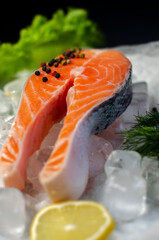 red fish steak on ice with herbs and spices