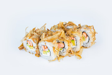 Japanese Sushi Roll with roasted salmon, avocado and Philadelphia cream cheese isolated on gray background. Asian dish with tuna chips (Bonito). Single object
