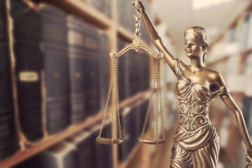 Lady Themis with scales of justice and stack books
