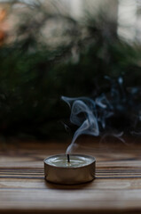 candle on the background of Christmas tree branches