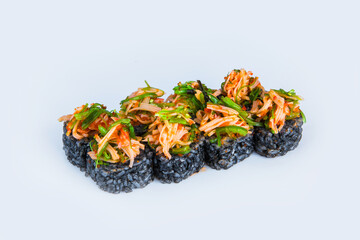 Japanese Volcano Sushi Roll with black rice isolated on gray. Asian food with marinated Snow crab meat (crab sticks), flying fish roe (tobiko) and hiyashi wakame chukka on top. Menu dish isolation.