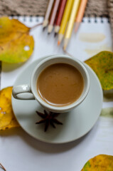 autumn coffee cup on the table with books and old camera