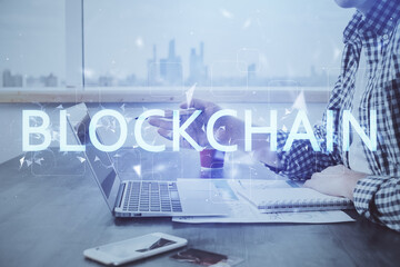 Blockchain theme hud with man working on computer on background. Concept of crypto chain. Double...