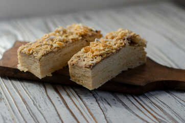 Napoleon cake on a table with sweets