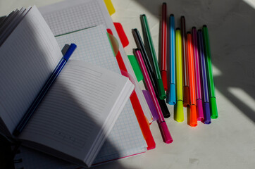 note book with markers on white background