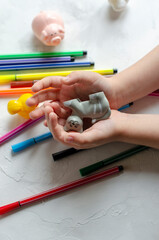 children's hands with toys and felt-tip pens