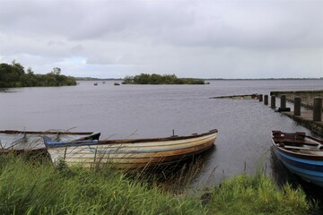Fototapeta na wymiar Old rowing boats abandoned on the shore of Lough Mask, County Mayo, Ireland.