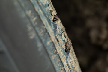 Car tire with adhering dirt. SUV wheel. Tire tread. Off-road dirty car. Detail of a car with...