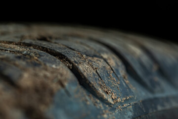 Car tire with adhering dirt. SUV wheel. Tire tread. Off-road dirty car. Detail of a car with...
