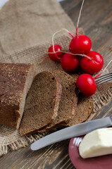 black bread on the table with radish and butter