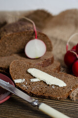 black bread on the table with radish and butter