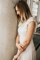 Smiling attractive woman wearing white dress indoor