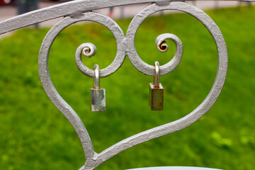 Two locks on heart shaped metal structure