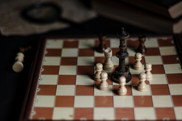 chess on the table next to a stack of books