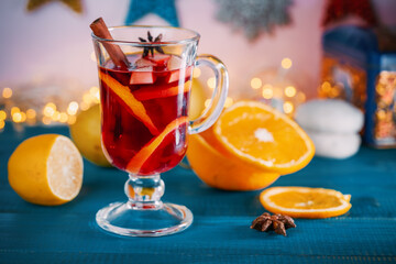 Refreshing sangria (punch) with fruits on the background of Christmas toys and luminous garlands