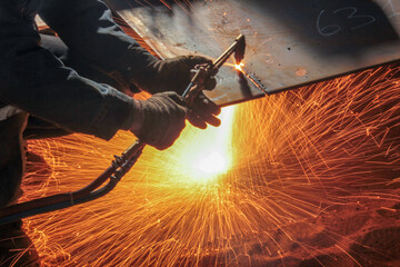 Cutting metal plate with oxygen. Oxy-fuel welding (commonly called oxyacetylene welding, oxy...