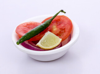 Chili, Tomato, lemon and onion in white bowl on white background