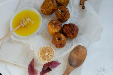 baked apples with honey on a clay plate