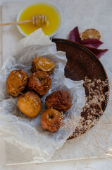 baked apples with honey on a clay plate
