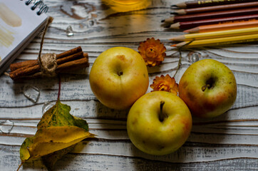 apples with autumn flowers and leaves on the table