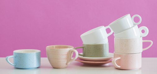 Fototapeta na wymiar modern cups on white table on background pink wall