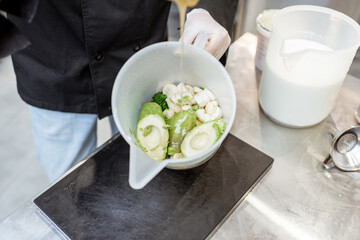 Chef mixing healthy ingredients for an exotic ice cream making, close-up