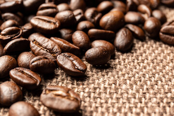 Roasted coffee beans on sackcloth.