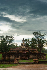 Fototapeta na wymiar a Buddha statue in ruin of temple at Sukhothai Historical park, Thailand