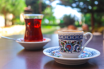 Turkish coffee and tea in traditional cups in a street restaurant. Close-up, selective focus.