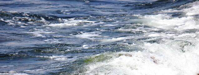 Waves crashing stones on the beach
