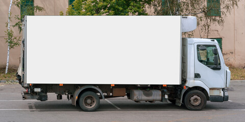 cargo truck with big empty bodywork with white mock-up place for advertising commercial information...
