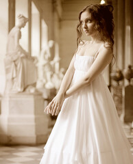 Naklejka premium Portrait of a beautiful young victorian lady in white dress