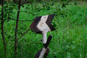 Arrow on the railroad. Railway arrow on an old road in the grass