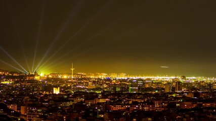 Time-lapse over the city of Barcelona. We can see the cargo loading port. The Montjuic Olympic Stadium. The communication tower of Barcelona and various buildings in the city.