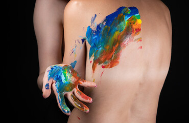 Image of woman messing up rainbow on nude back