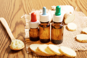 Ginger essential oil in a small bottle. Selective focus.