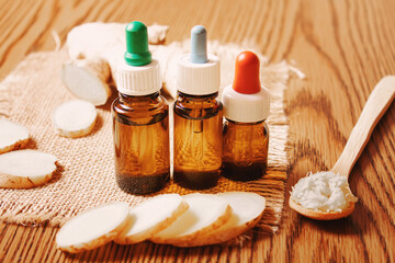 Ginger essential oil in a small bottle. Selective focus.