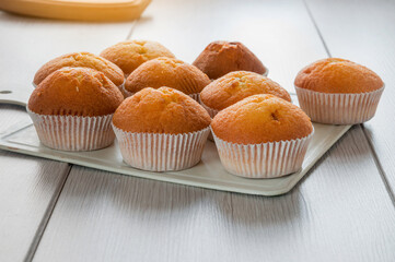 Delicious cupcakes close-up on a wooden board. Selective focus. The finished baked goods were taken...