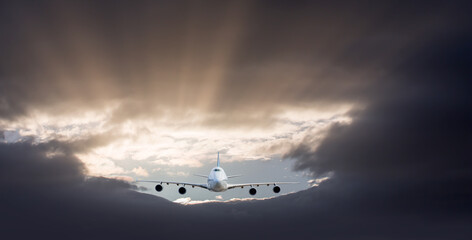 Commerical airplane flying under the storm clouds - obrazy, fototapety, plakaty