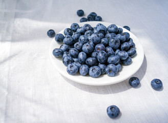 Blueberries on a small plate. Berries on the table.