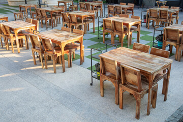 Empty wooden food table and chair at outdoor restaurant.