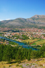 Fototapeta na wymiar Beautiful sunny summer landscape. View of Trebinje city from Crkvina Hill. Bosnia and Herzegovina, Republika Srpska