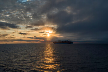 Obraz na płótnie Canvas large container ship on the background of sunset side view