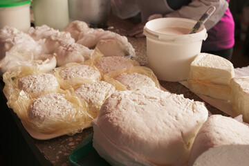 Homemade cottage cheese with milk on the table close-up