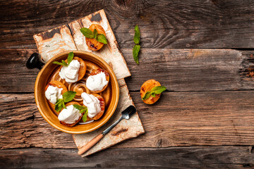 Fototapeta na wymiar still life with grilled peaches, apricots, nectarines and ice cream on a wooden background. banner, catering menu recipe place for text, top view