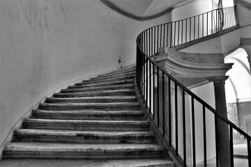 Spiral marble staircase inside Palazzo Barberini in Rome. Black and white photos.