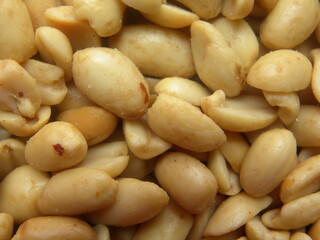 Brownish white color dry roasted and salted peanuts with skin removed