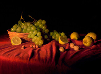 Wihte grapes in a wicker basket with lemons and nuts