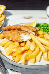 Traditional English Food such as Fish and Chips with green peas served in the Pub or Restaurant